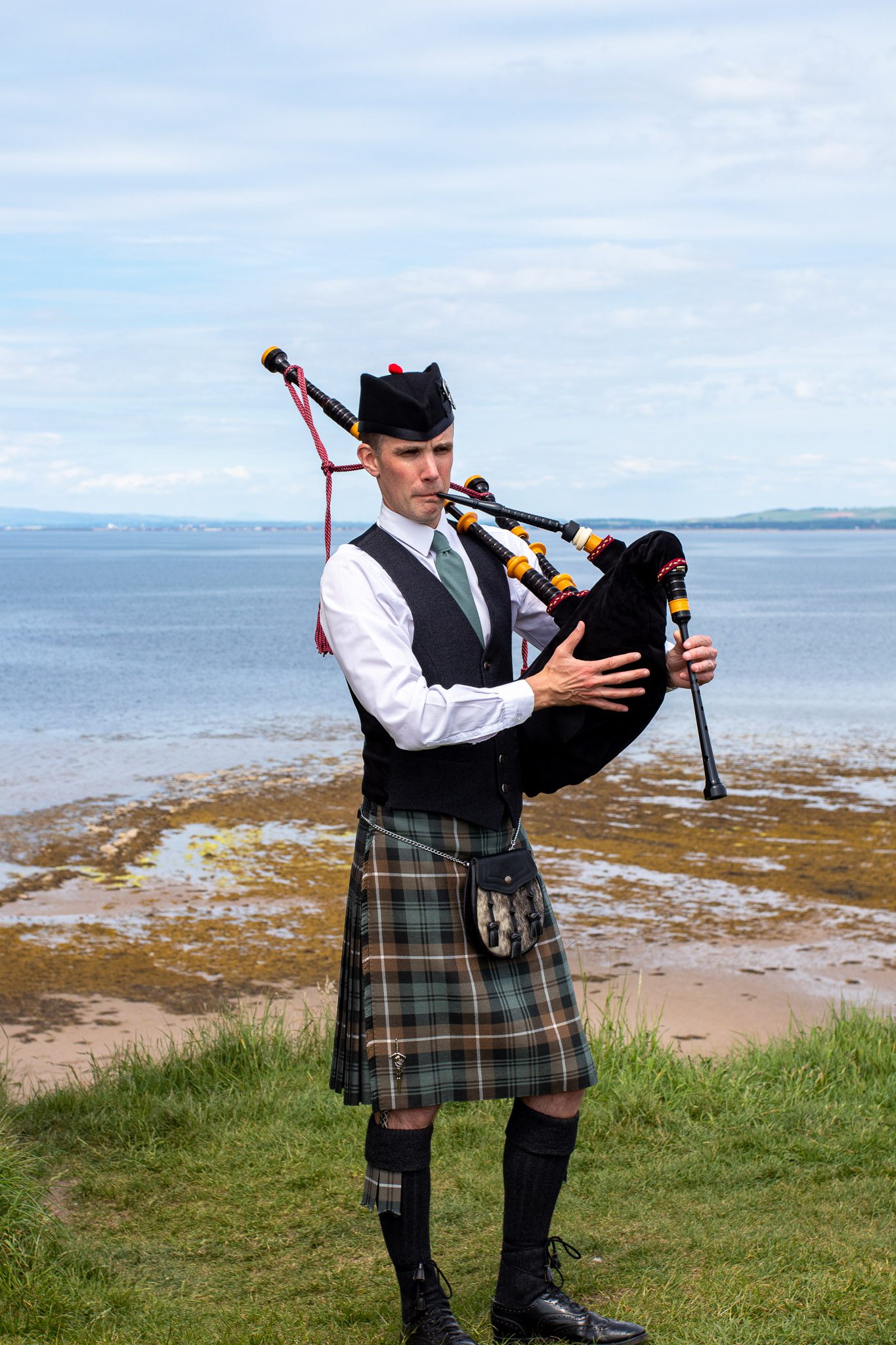 Alistair Brown Ayrshire Piper playing bagpipes and wearing lamont kilt at Greenan Shore in Ayr, Scotland (33 of 74)