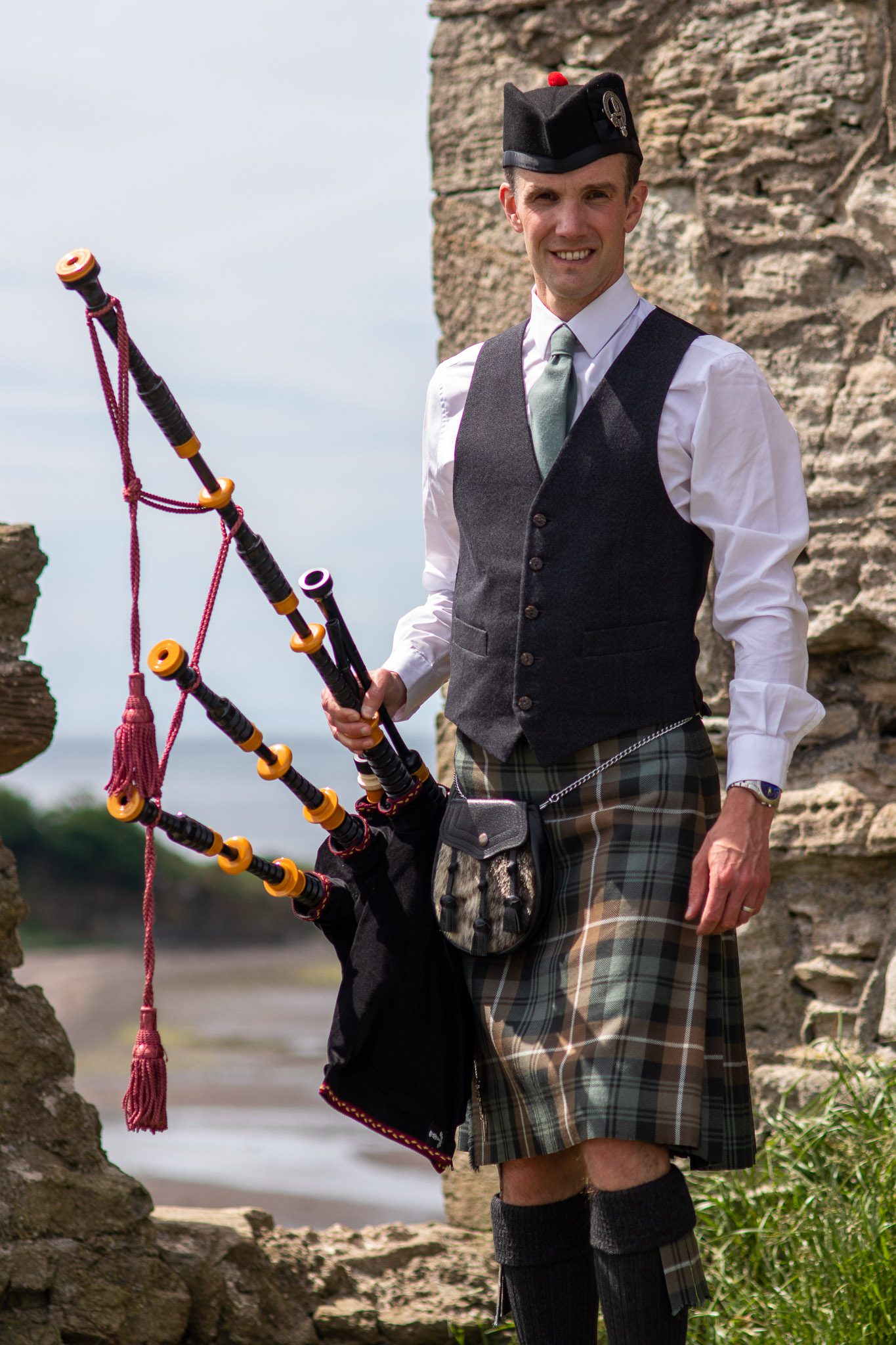 Alistair Brown Ayrshire Piper playing bagpipes and wearing lamont kilt at Greenan Shore in Ayr, Scotland (52 of 74)