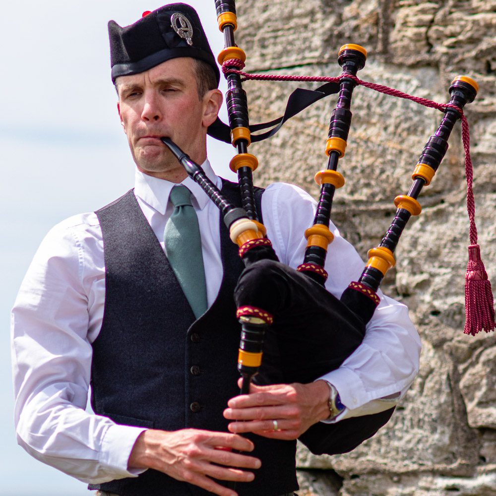 Alistair Brown playing bagpipes and wearing lamont kilt at Greenan Shore in Ayr, Ayrshire 3